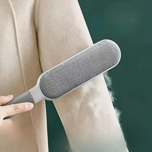 Reusable lint remover brushing pet hair off a knitted sweater