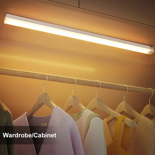 Warm white motion sensor LED light bar lighting a wardrobe rail