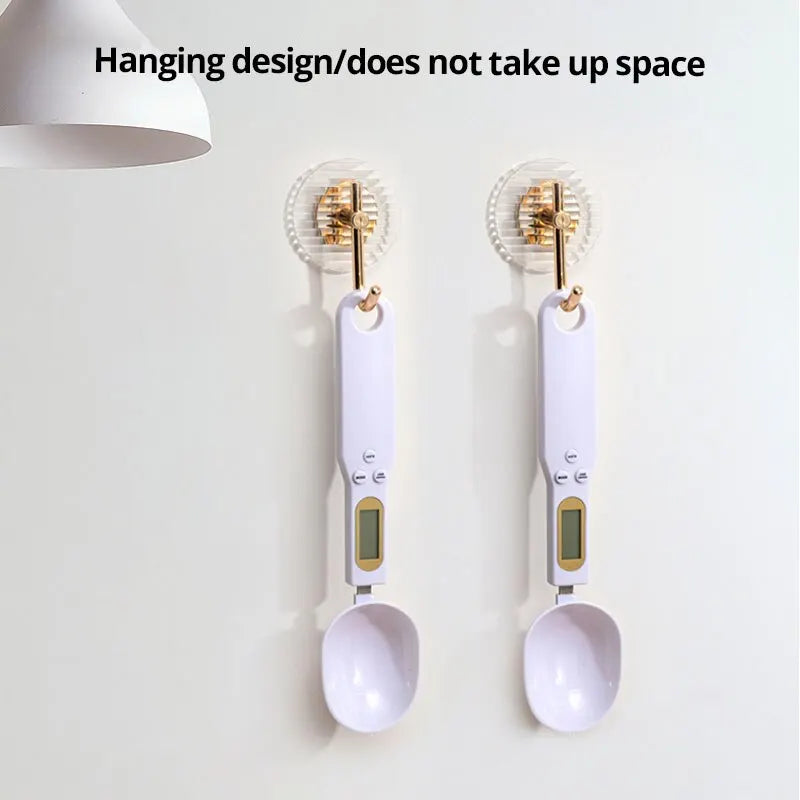 Two spoon scales hanging from hooks by the hole in the handle