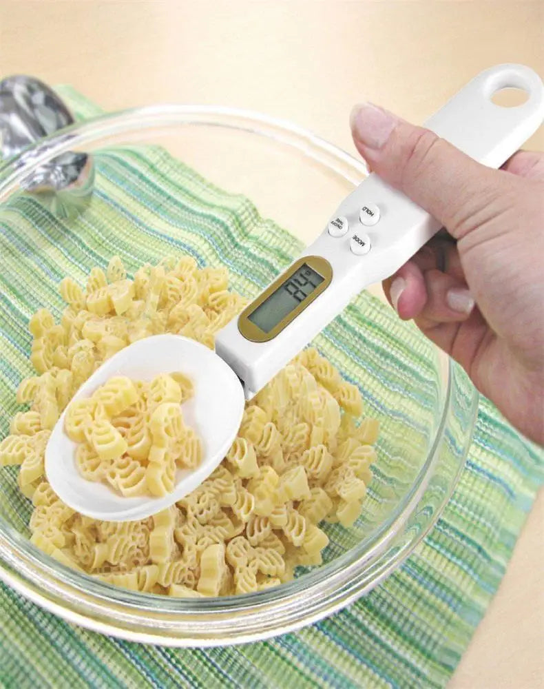 Weighing dry pasta from a glass bowl with the spoon scale