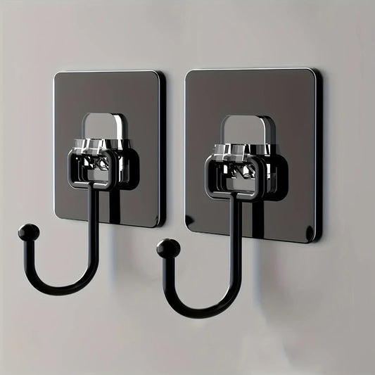Two black adhesive wall hooks mounted on a wall