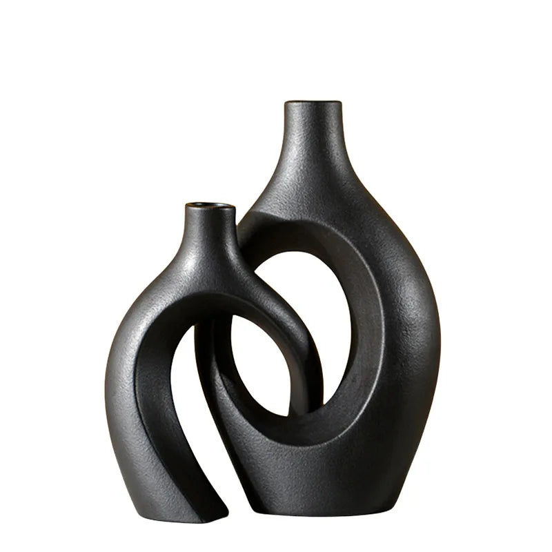 Black and cream snuggle vase set, taller black vase nesting the cream vase