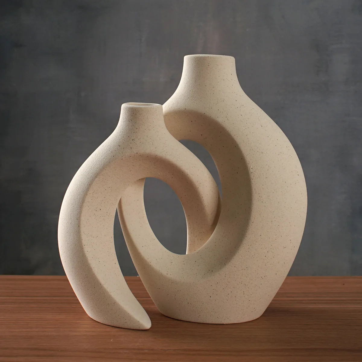Cream Nordic snuggle vase set on a wooden console against a grey wall