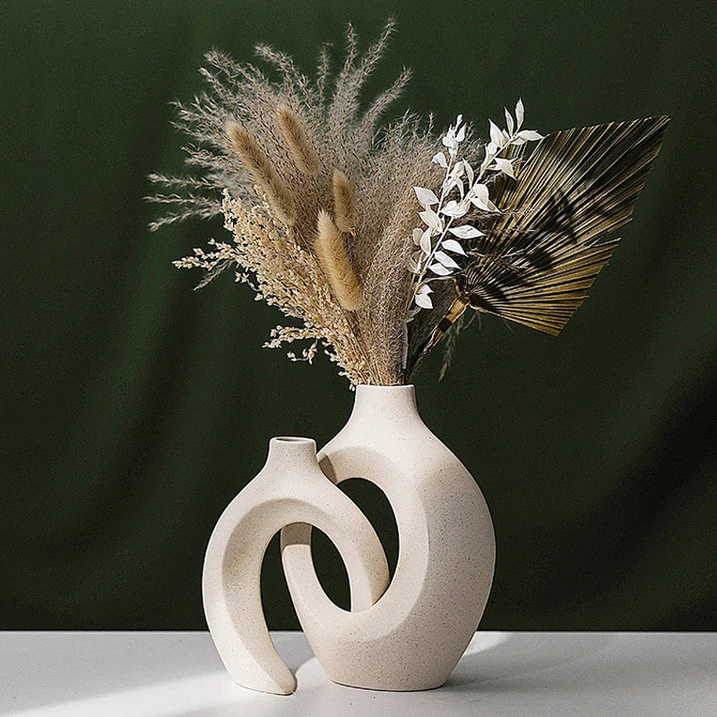 Cream interlocking ceramic vases holding a large dried flower arrangement