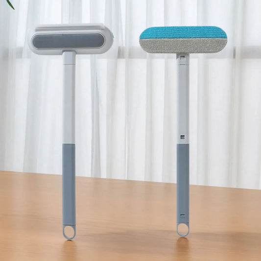 Long-handle reusable pet hair brush standing on a floor