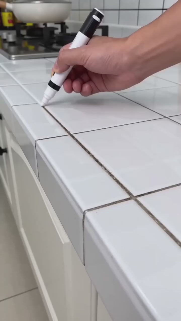 Grout pen restoring stained tile seams in a kitchen and bathroom